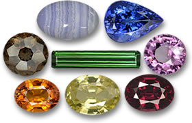In senso orario dall'alto a sinistra: agata, tanzanite, spinello, rodolite, granato del Mali, zaffiro, quarzo fumé e tormalina